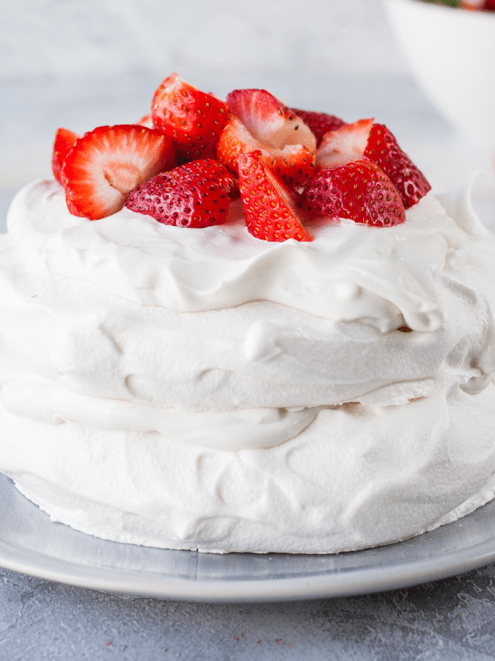 Eggless Pavlova made with aquafaba and served with strawberries and vegan cream