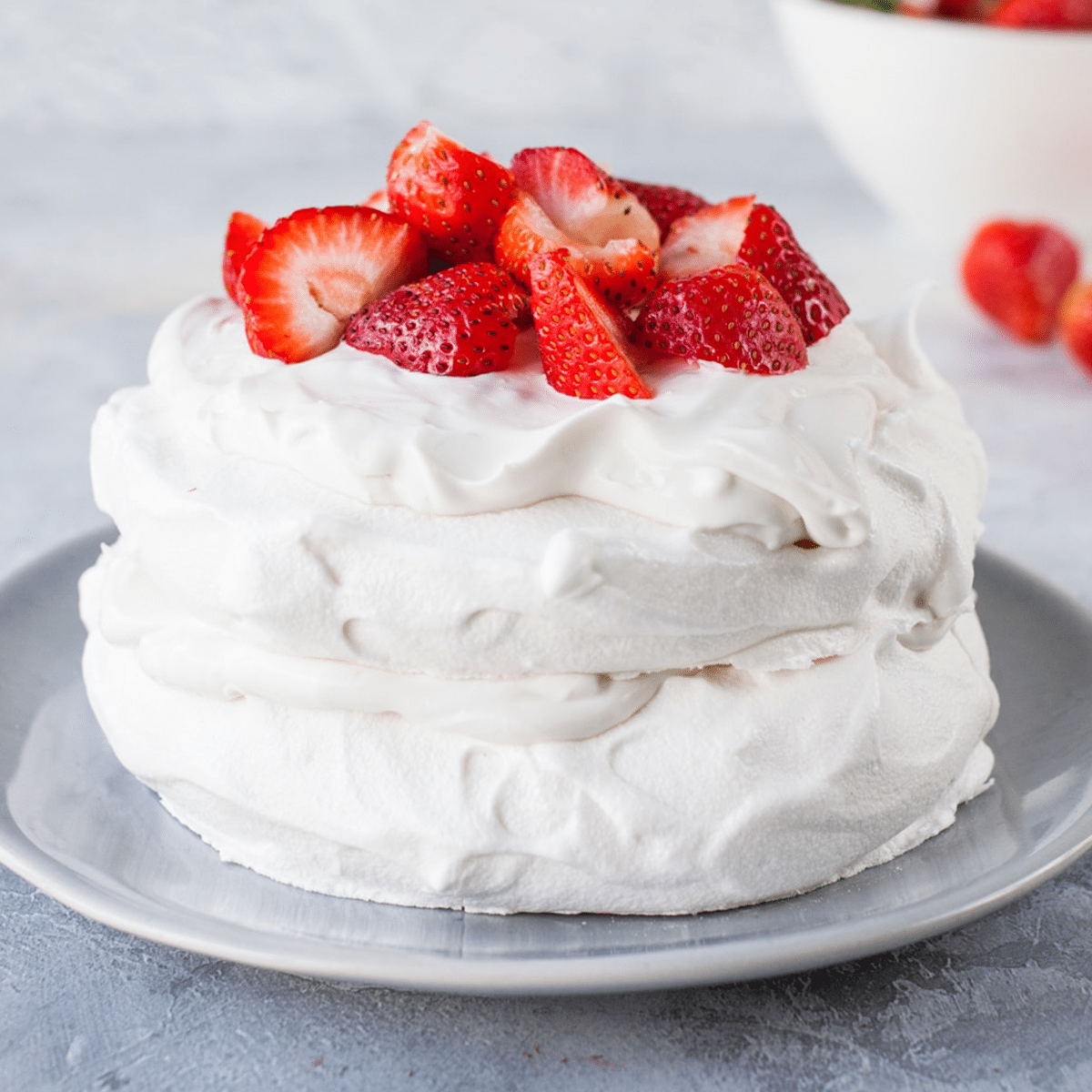 Eggless Pavlova made with aquafaba and served with strawberries and vegan cream