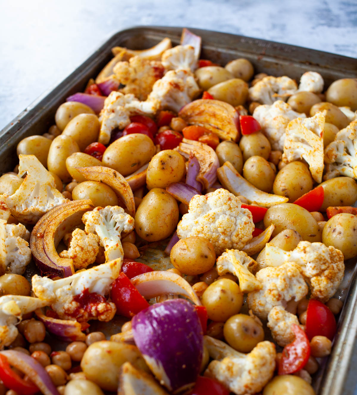 Marinated vegetables on tray, ready to be baked