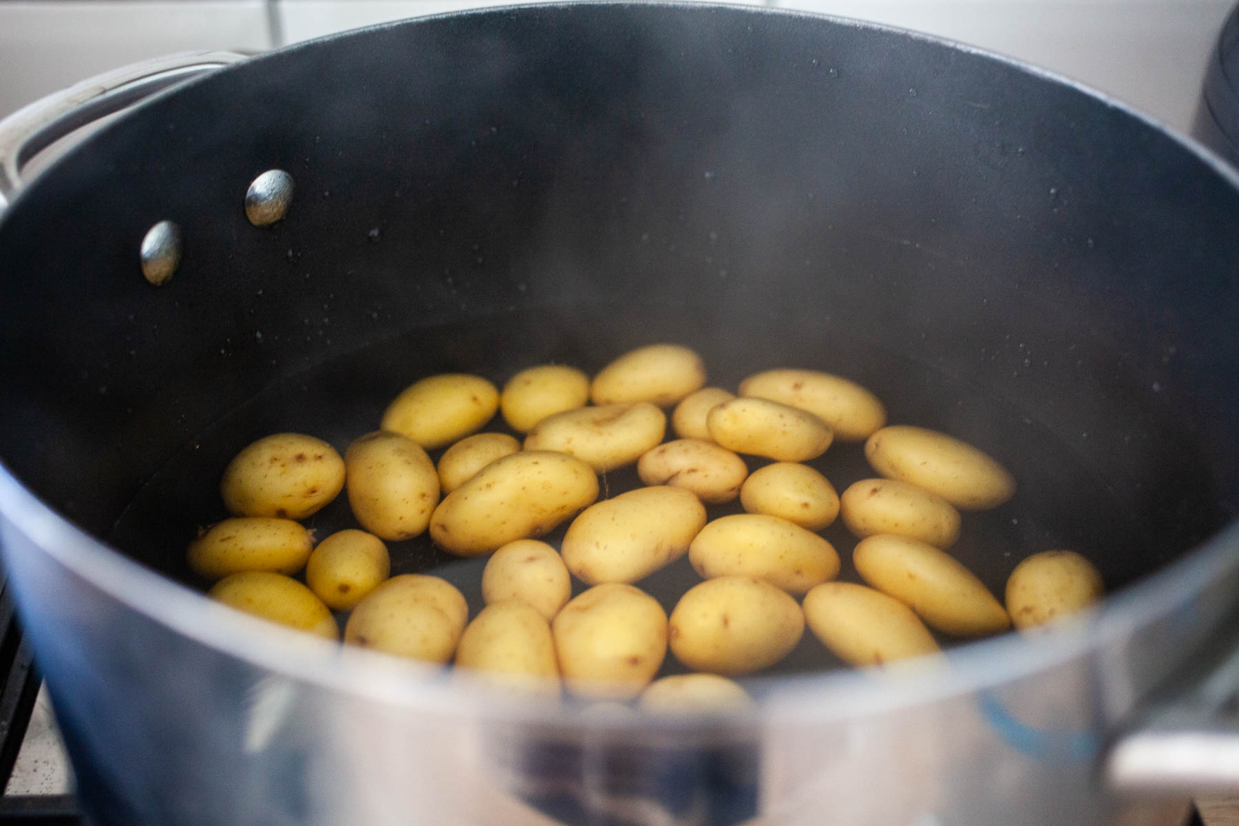 Boiling baby potatoes in a large pot